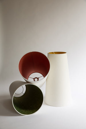 Big ceiling lampshades in tall cone shape. made in white linen but lined in six different jewel-like silks.